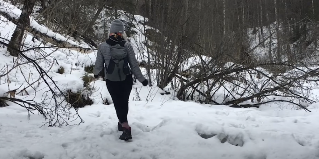 Woman Hiking in Snowy Terrain"