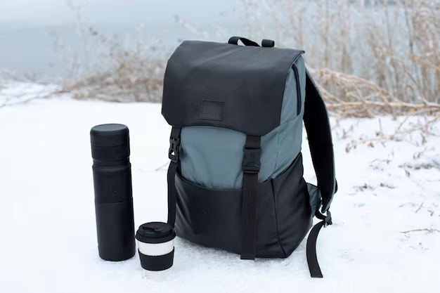 Backpack and Tumbler on Snow-Covered Surface