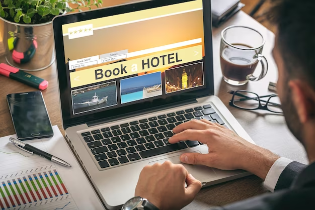Man booking a hotel on his laptop.