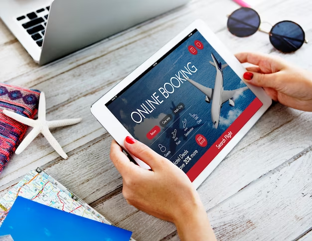 Hand Using Tablet to Book Flight Online