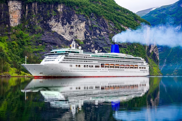 Cruise ship on water with mountains in the background